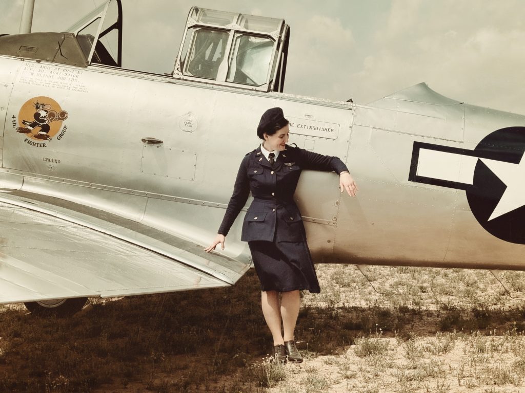 Noëlle in her second replica uniform in front of a T-6 at Avenger Field, April 2024.